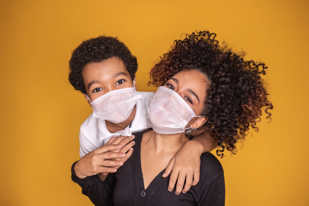 mother and son wearing a face mask for COVID protection