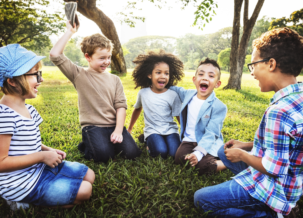 kids sitting outside playing together